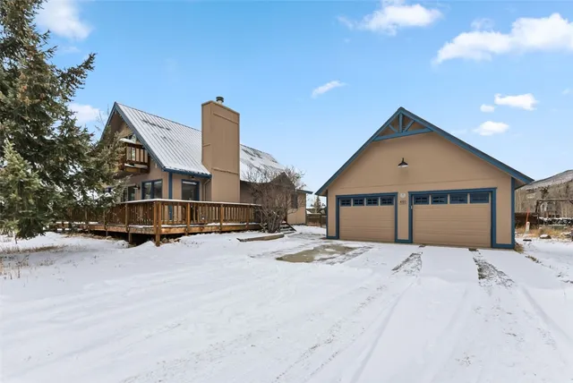 a view of a house with wooden fence