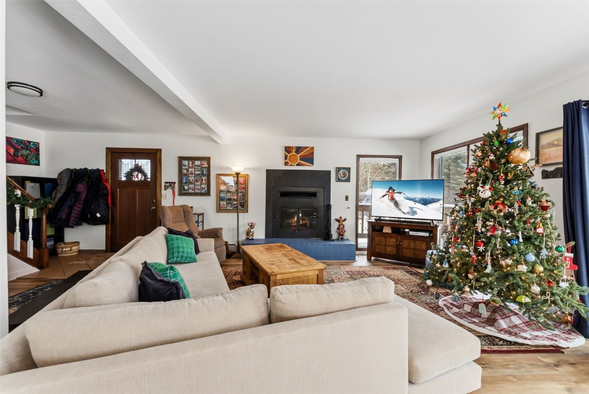 460 Clayton Road Silverthorne, CO 80498 - Photo 41 of 50 a living room with furniture a fireplace and a flat screen tv