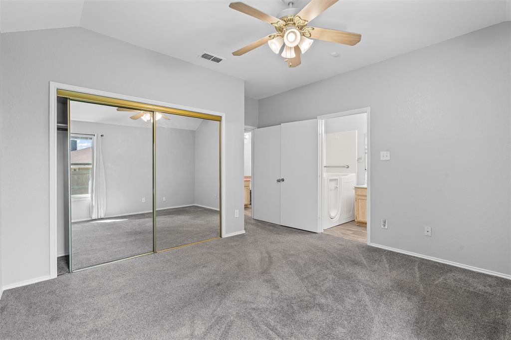 7301 Wagonwheel Road Fort Worth, TX 76133 - Photo 11 of 34 an empty room with closet and a chandelier fan