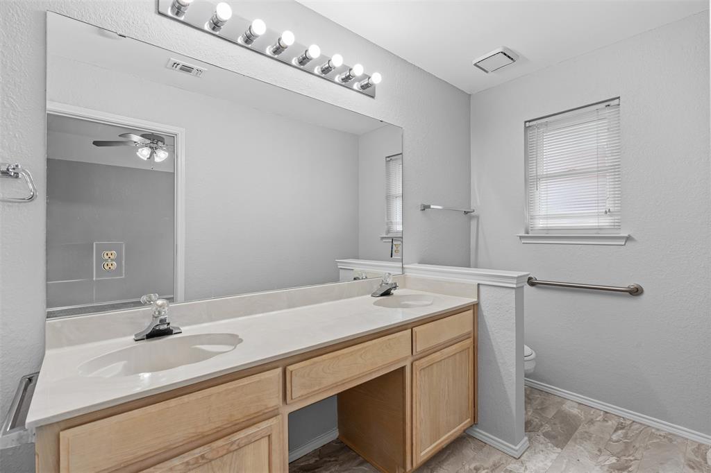 7301 Wagonwheel Road Fort Worth, TX 76133 - Photo 12 of 34 a bathroom with a sink and a mirror