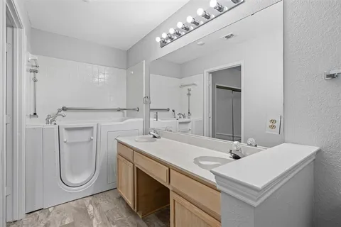 a bathroom with a sink vanity and mirror