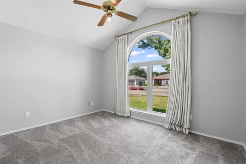 an empty room with a window and front door