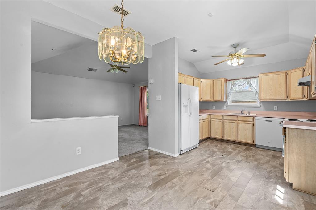 7301 Wagonwheel Road Fort Worth, TX 76133 - Photo 22 of 34 a view of a kitchen with a sink and dishwasher with white walls