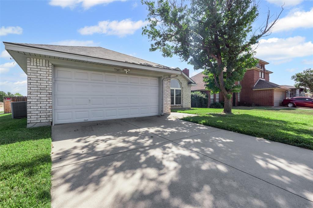 7301 Wagonwheel Road Fort Worth, TX 76133 - Photo 7 of 34 a view of a house with a small yard