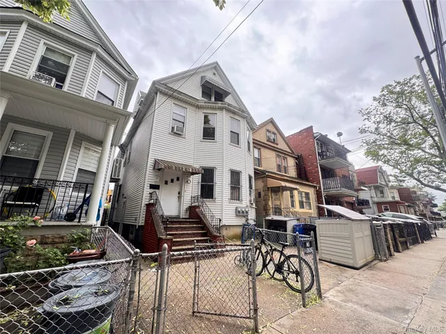 a view of a white building with many windows