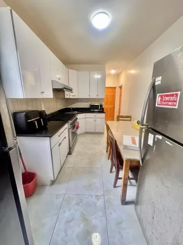 a bathroom with a sink a toilet a mirror and shower