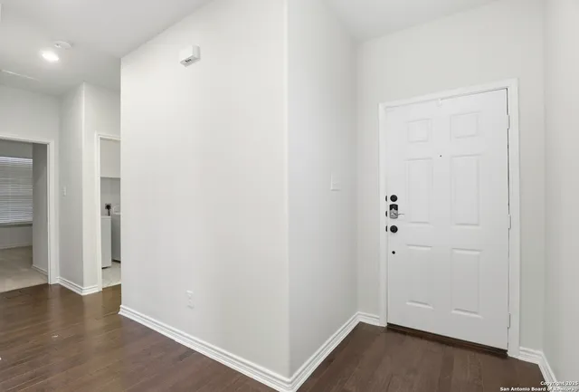 an empty room with wooden floor