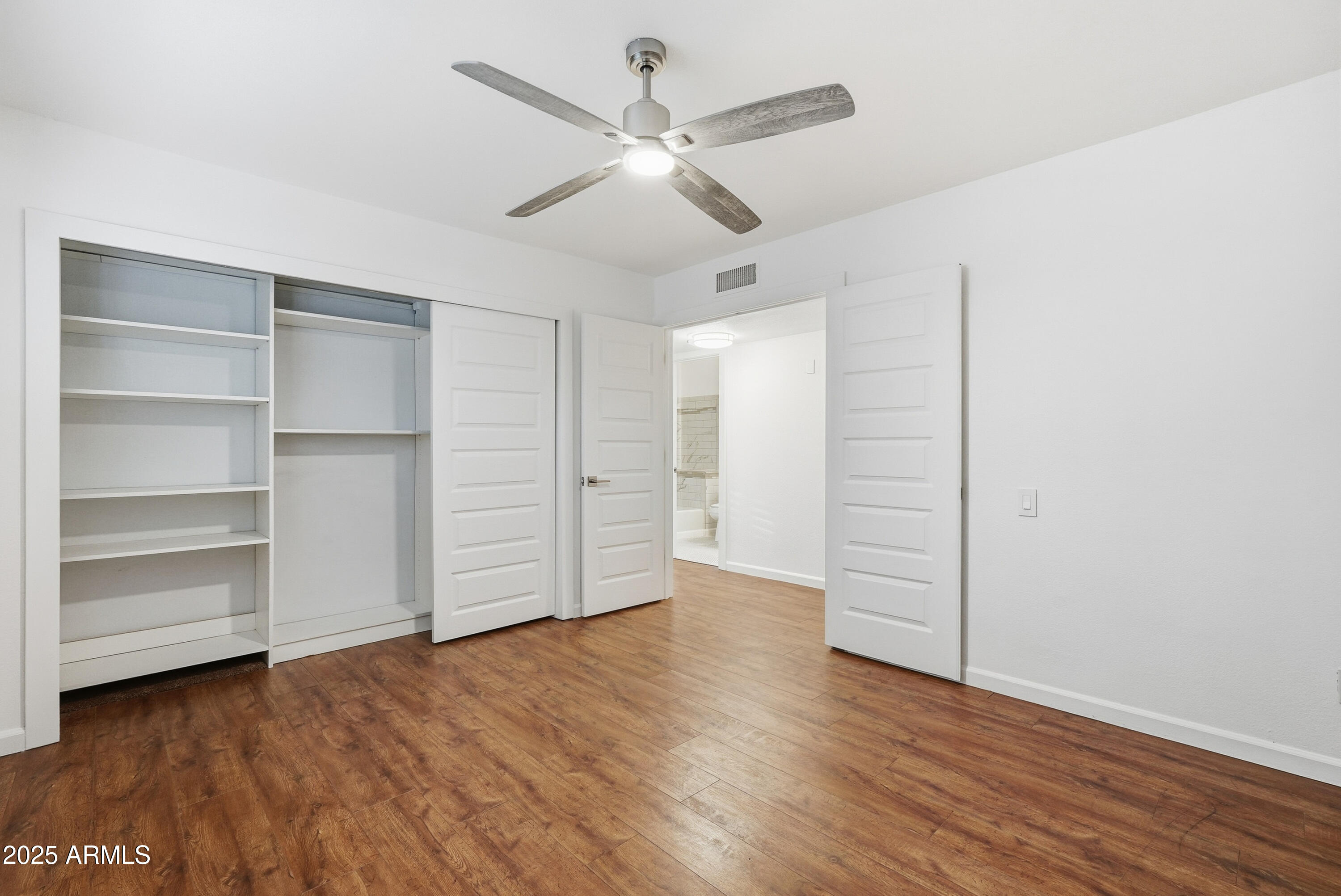 5632 South Jolly Roger Road Tempe, AZ 85283 - Photo 11 of 35 a view of an empty room with a ceiling fan window and a ceiling fan
