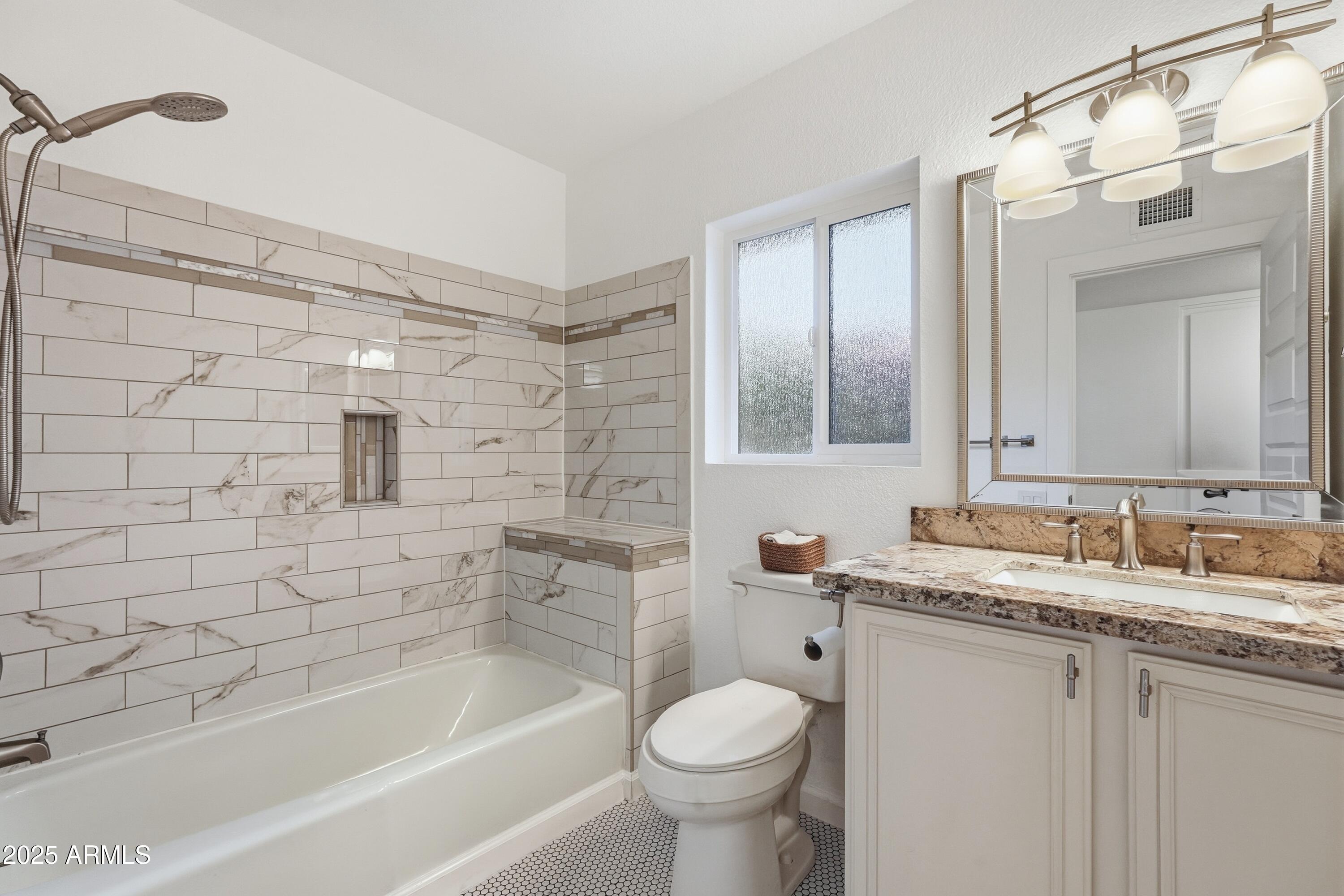 5632 South Jolly Roger Road Tempe, AZ 85283 - Photo 12 of 35 a bathroom with a granite countertop sink toilet and shower