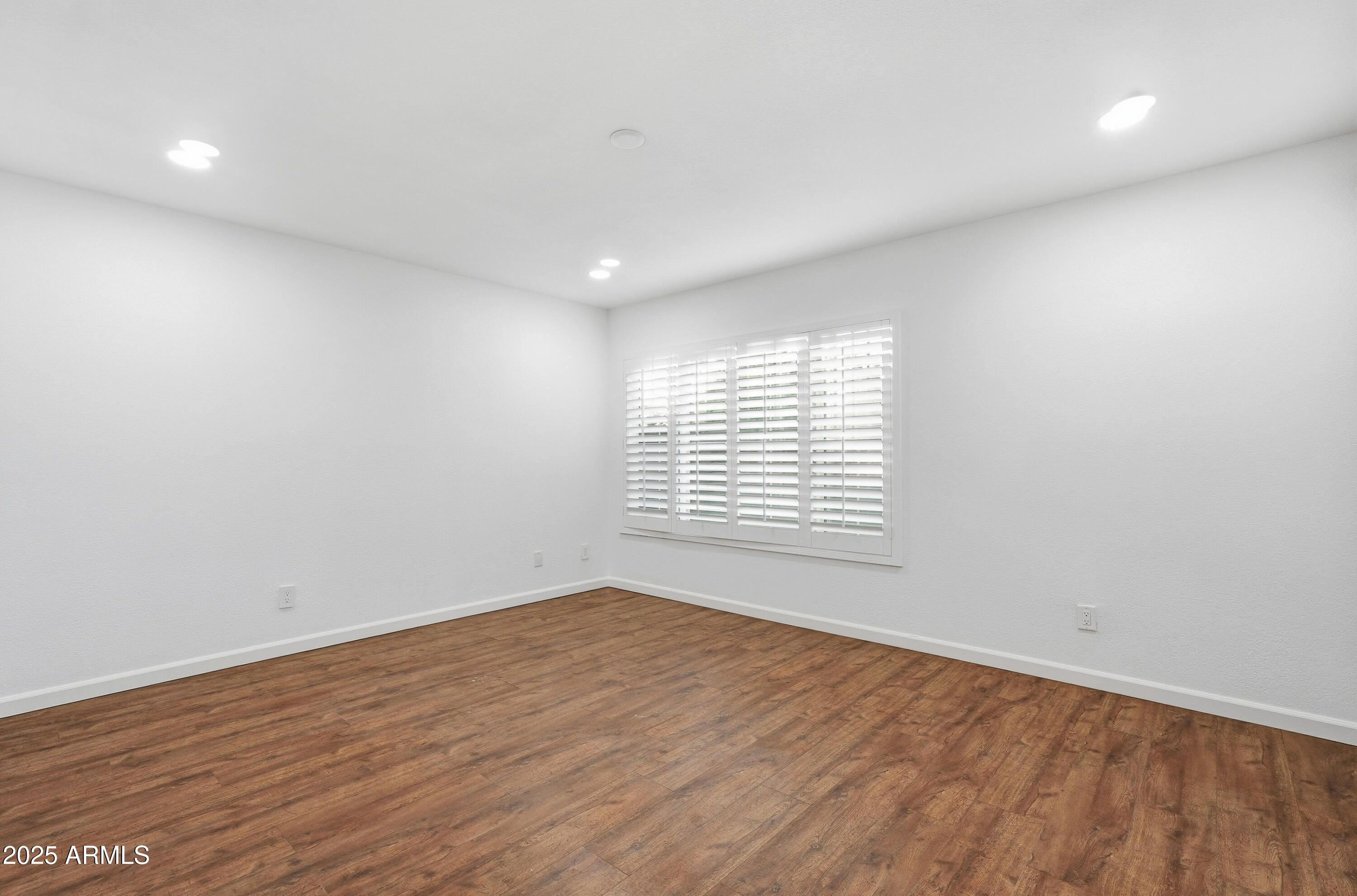 5632 South Jolly Roger Road Tempe, AZ 85283 - Photo 13 of 35 a view of an empty room with wooden floor and a window