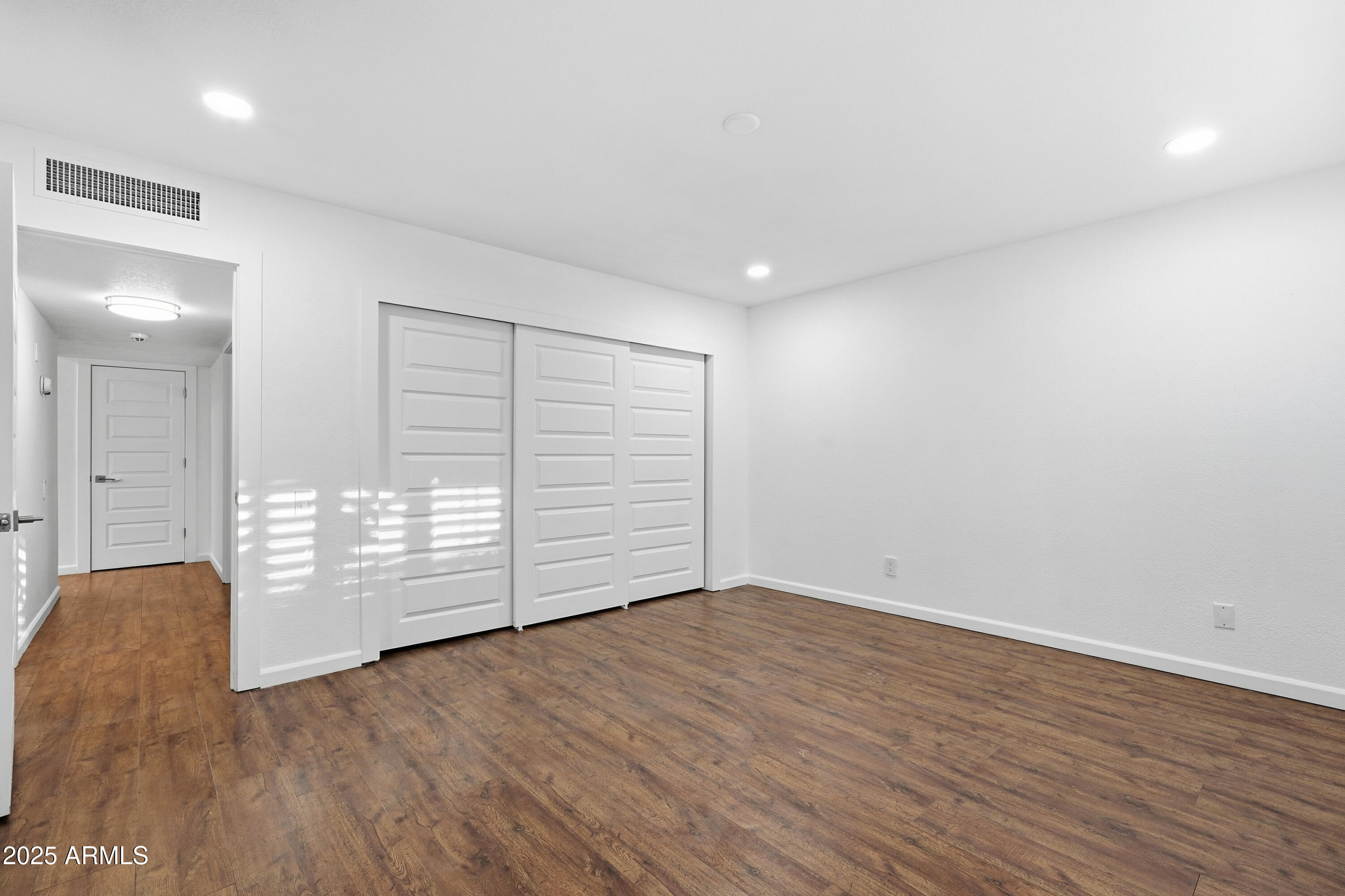 5632 South Jolly Roger Road Tempe, AZ 85283 - Photo 14 of 35 wooden floor in an empty room with a window