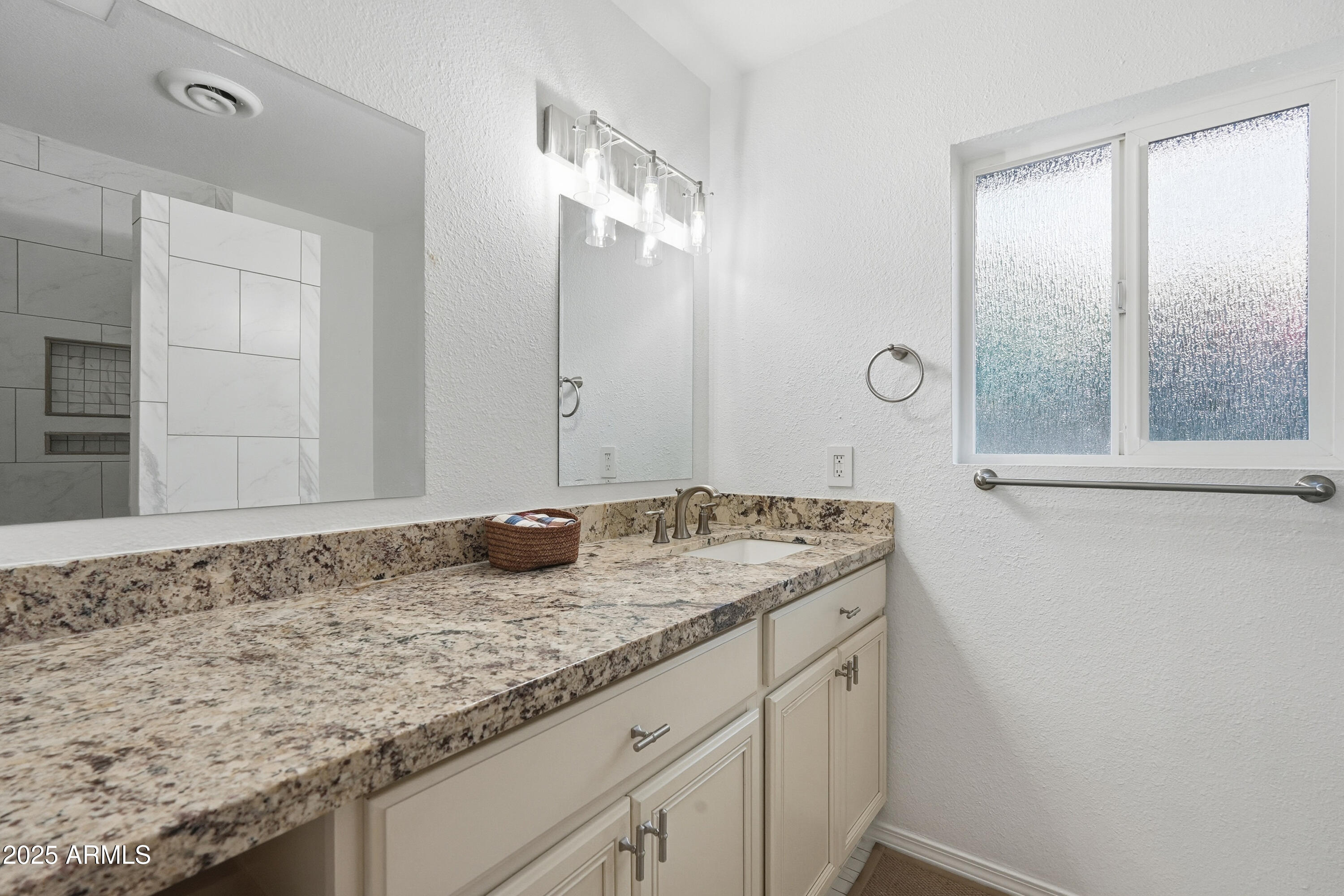 5632 South Jolly Roger Road Tempe, AZ 85283 - Photo 15 of 35 a bathroom with a granite countertop sink and a mirror