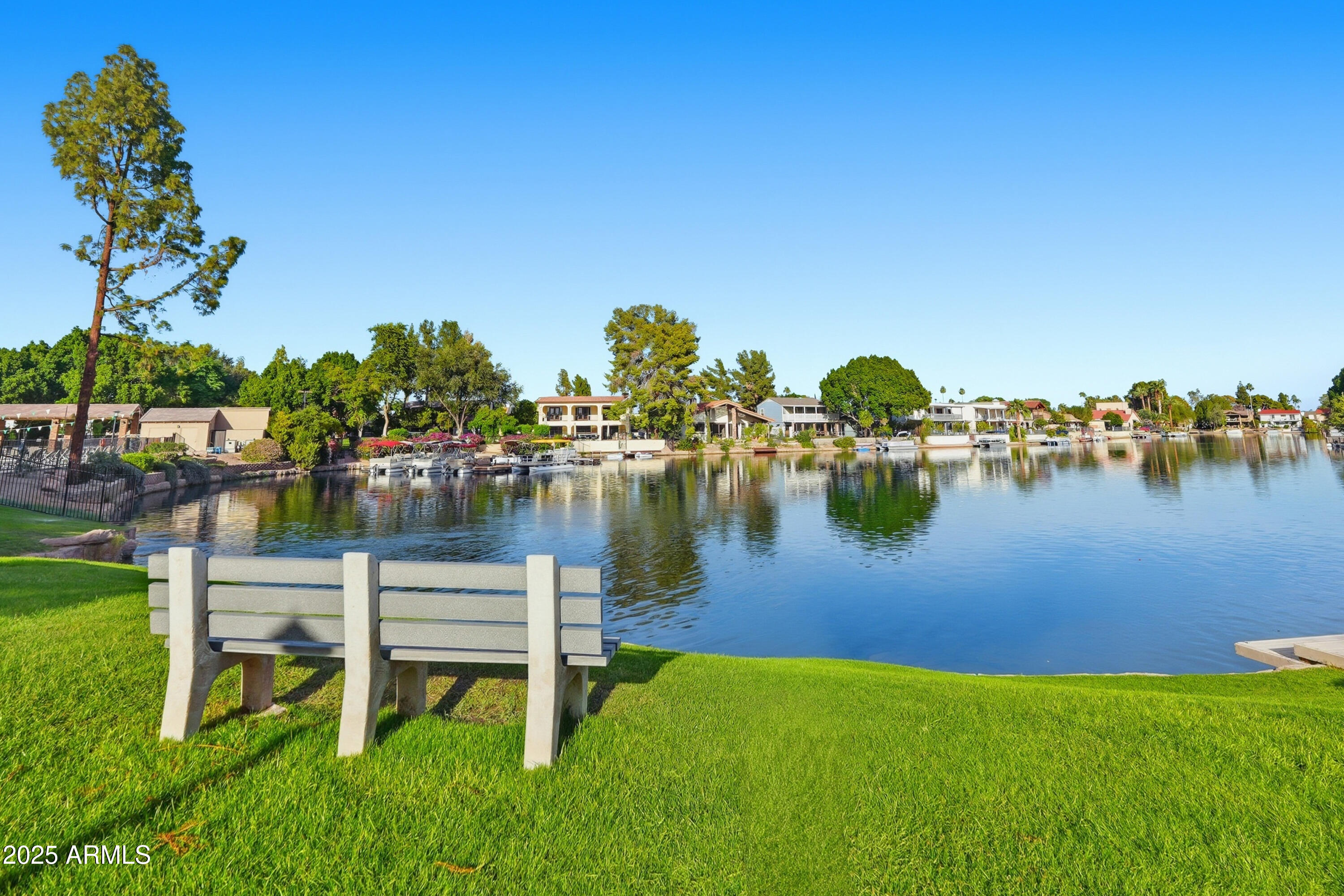 5632 South Jolly Roger Road Tempe, AZ 85283 - Photo 24 of 35 a view of a lake with houses in the back