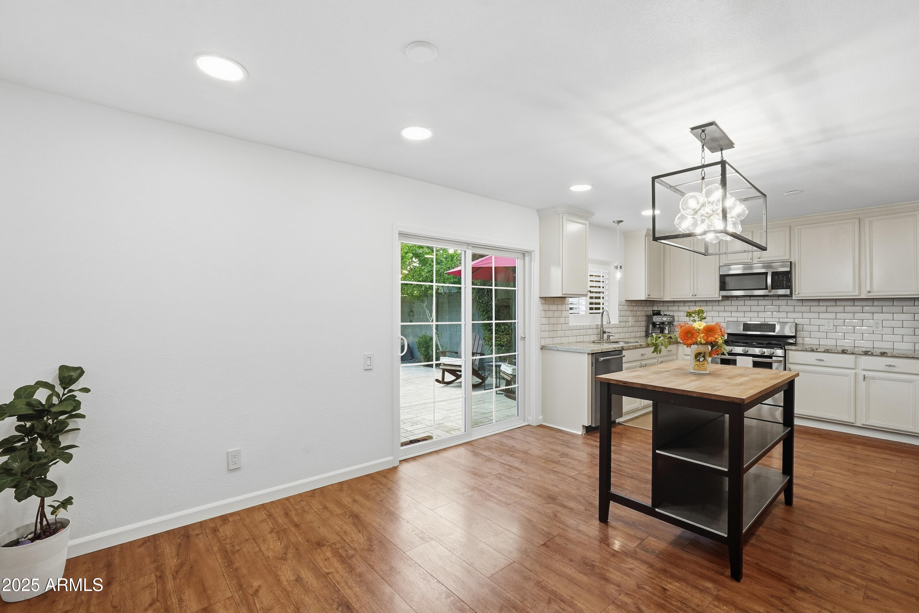 5632 South Jolly Roger Road Tempe, AZ 85283 - Photo 6 of 35 a kitchen with a sink cabinets and wooden floor