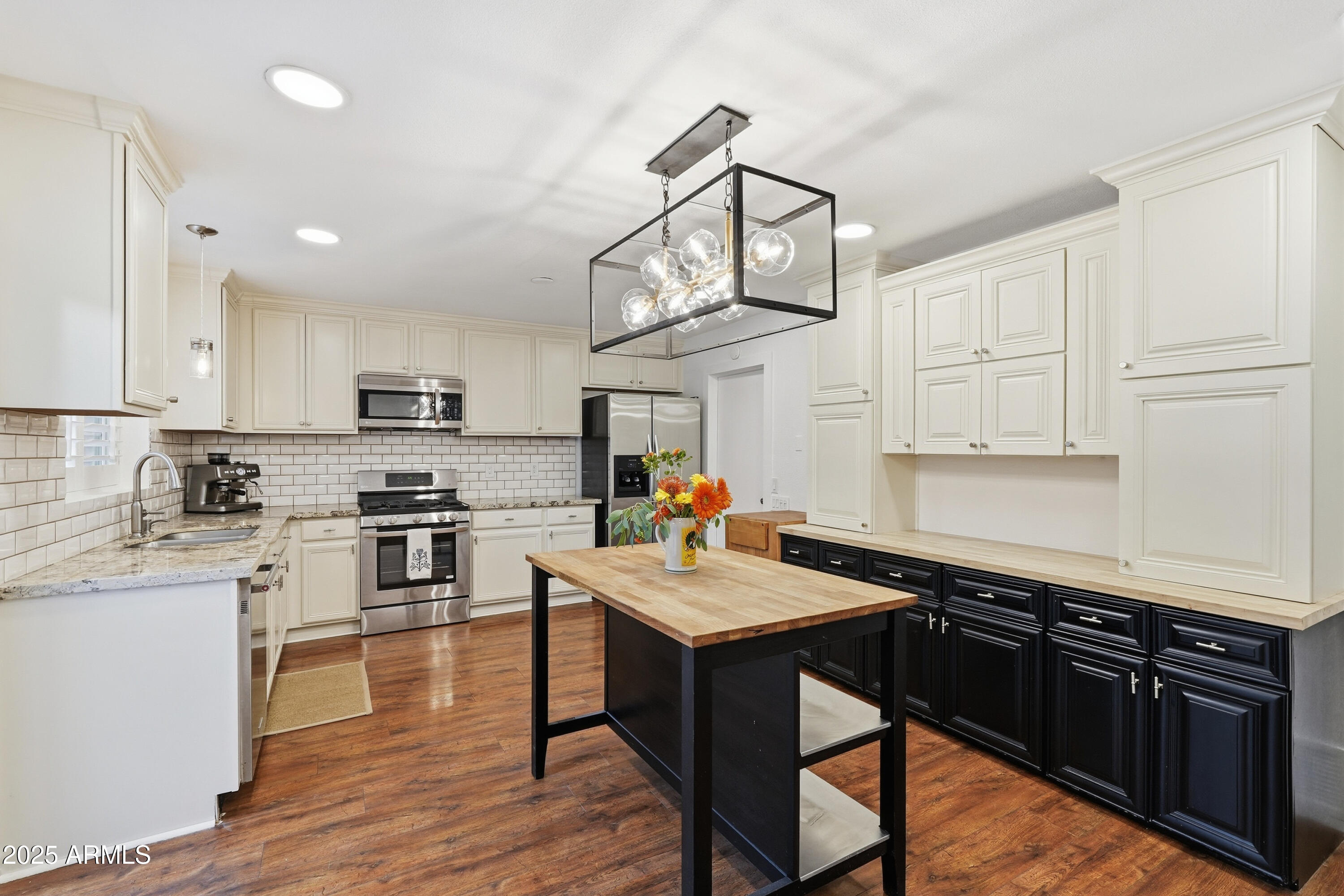 5632 South Jolly Roger Road Tempe, AZ 85283 - Photo 7 of 35 a kitchen with stainless steel appliances granite countertop a sink dishwasher stove refrigerator and cabinets with wooden floor
