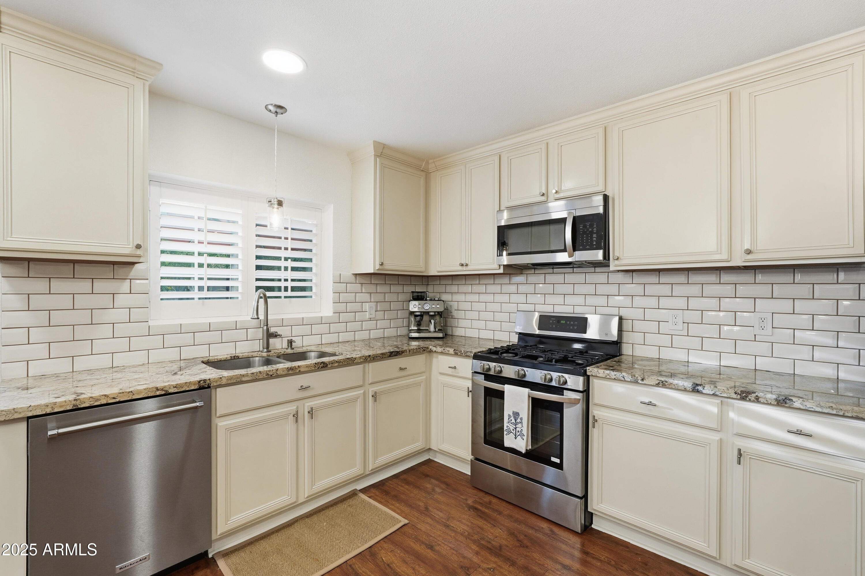 5632 South Jolly Roger Road Tempe, AZ 85283 - Photo 8 of 35 a kitchen with granite countertop white cabinets sink and stainless steel appliances