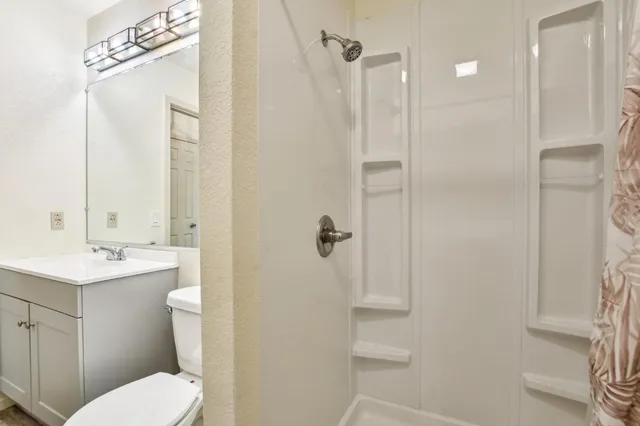 a bedroom with a large bed and a painting on the wall