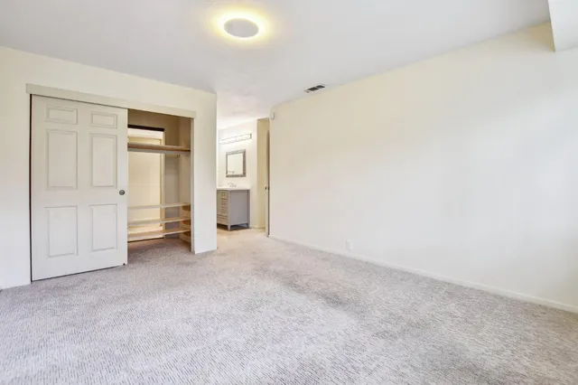 a bathroom with a granite countertop sink mirror and a bathtub