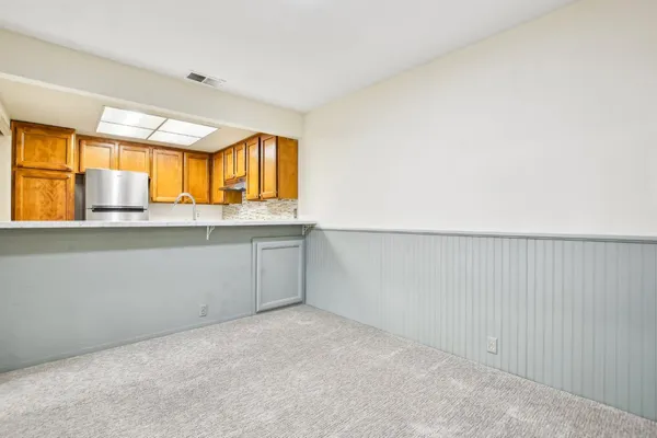 a kitchen with stainless steel appliances granite countertop a sink stove and cabinets