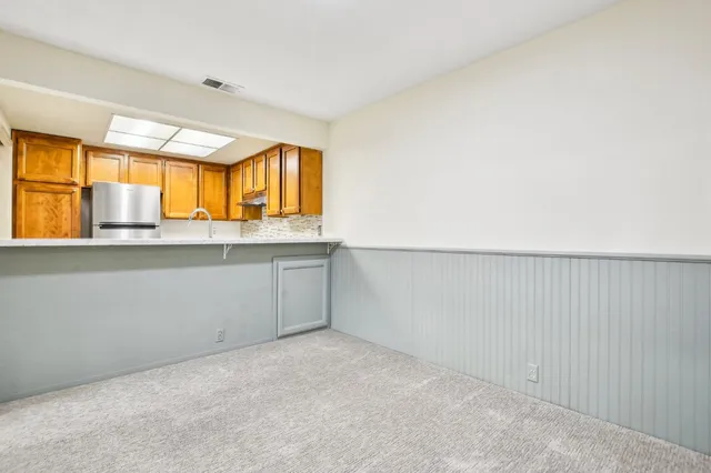 a kitchen with stainless steel appliances granite countertop a sink stove and cabinets