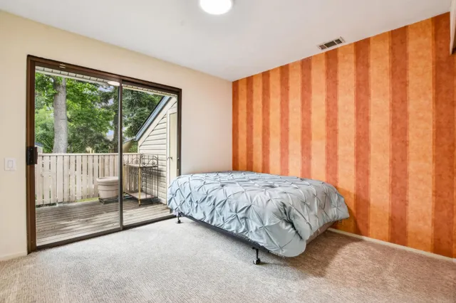 a bedroom with a bed and curtain