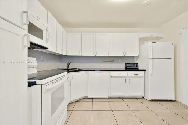 a bathroom with a sink a mirror and a shower curtain