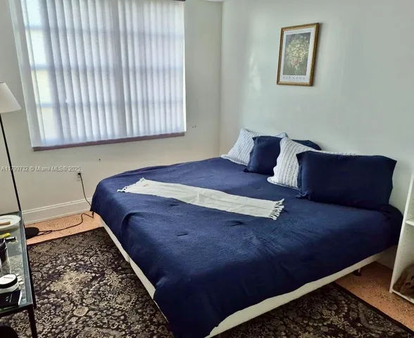 a bedroom with a bed and dresser