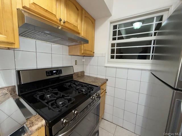 1020 Throggmorton Avenue, Unit 1 Bronx, NY 10465 - Photo 11 of 11 a stove top oven sitting inside of a kitchen