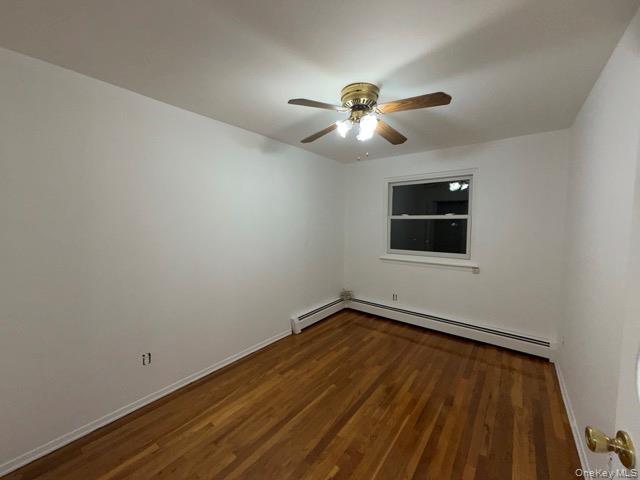 1020 Throggmorton Avenue, Unit 1 Bronx, NY 10465 - Photo 2 of 11 a view of a room with wooden floor and ceiling fan