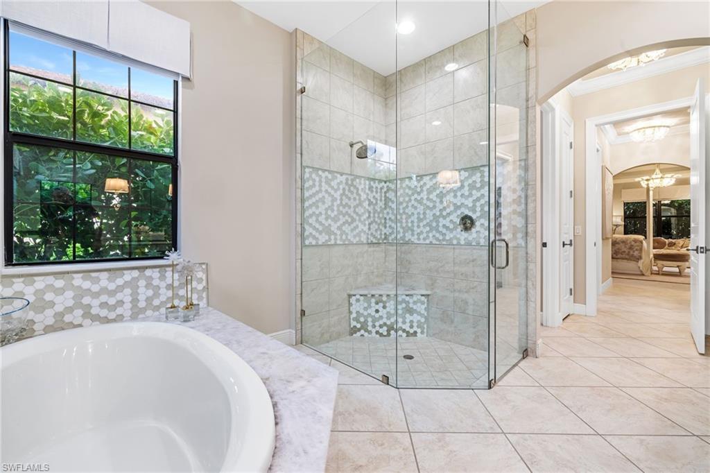 14480 Marsala Way Naples, FL 34109 - Photo 14 of 31 a bathroom with a bathtub and a shower
