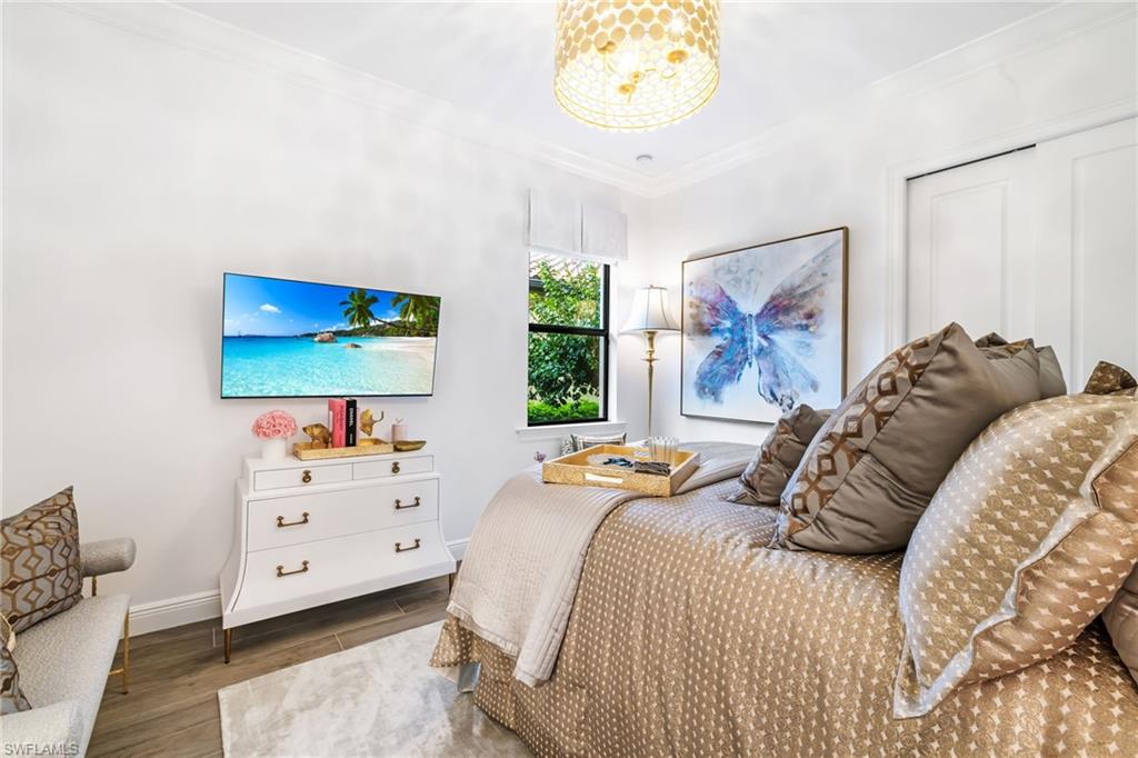 14480 Marsala Way Naples, FL 34109 - Photo 15 of 31 a bedroom with a bed and a flat screen tv