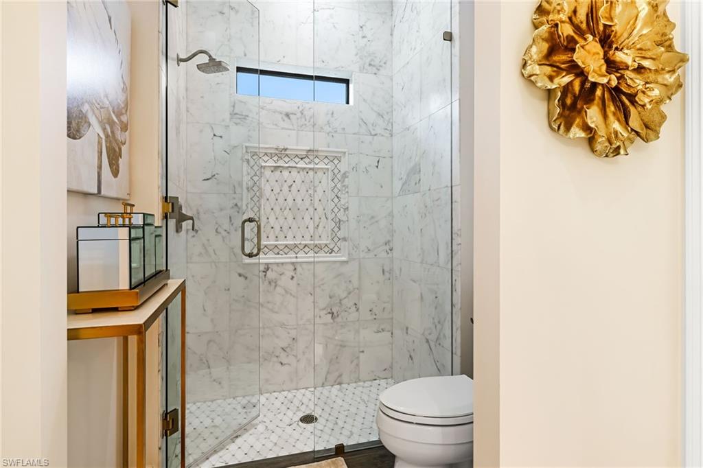 14480 Marsala Way Naples, FL 34109 - Photo 18 of 31 a bathroom with a shower and a toilet