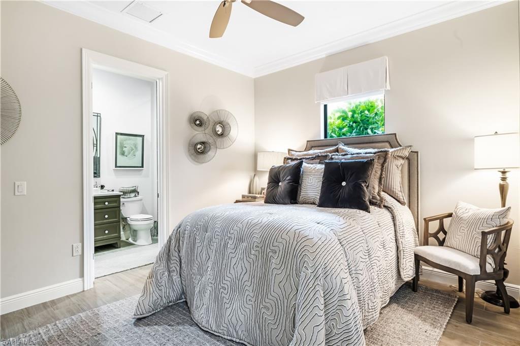 14480 Marsala Way Naples, FL 34109 - Photo 19 of 31 a bedroom with a bed and a chandelier