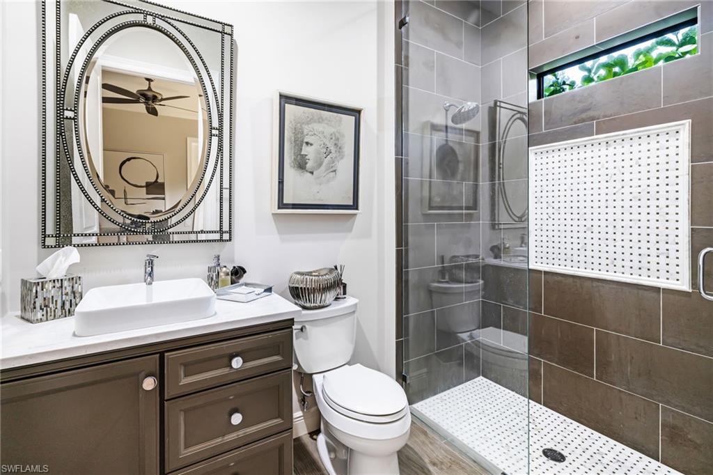 14480 Marsala Way Naples, FL 34109 - Photo 20 of 31 a bathroom with a toilet a sink and mirror