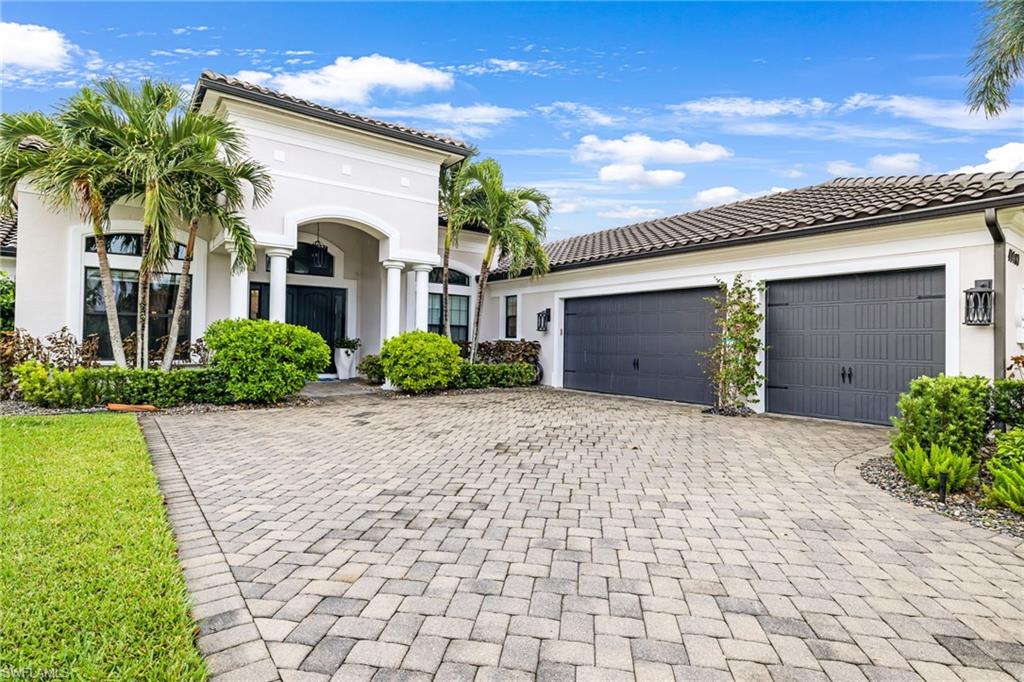 14480 Marsala Way Naples, FL 34109 - Photo 31 of 31 a front view of a house with a garden and garage