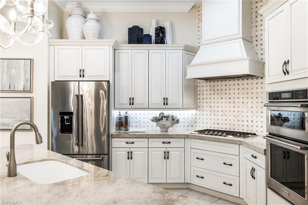 14480 Marsala Way Naples, FL 34109 - Photo 5 of 31 a kitchen with appliances a sink and cabinets