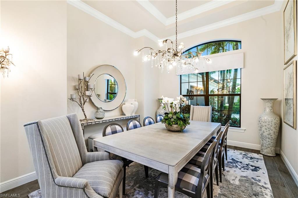 14480 Marsala Way Naples, FL 34109 - Photo 7 of 31 a view of a dining room with furniture a chandelier and wooden floor