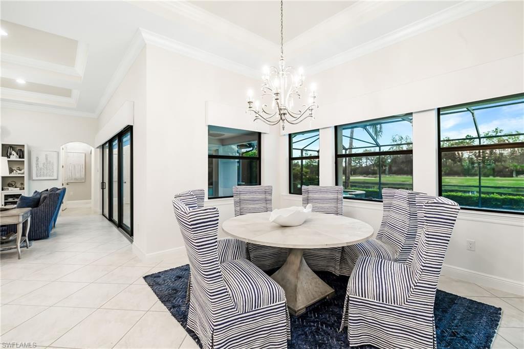 14480 Marsala Way Naples, FL 34109 - Photo 10 of 31 a view of a dining room with furniture wooden floor and chandelier