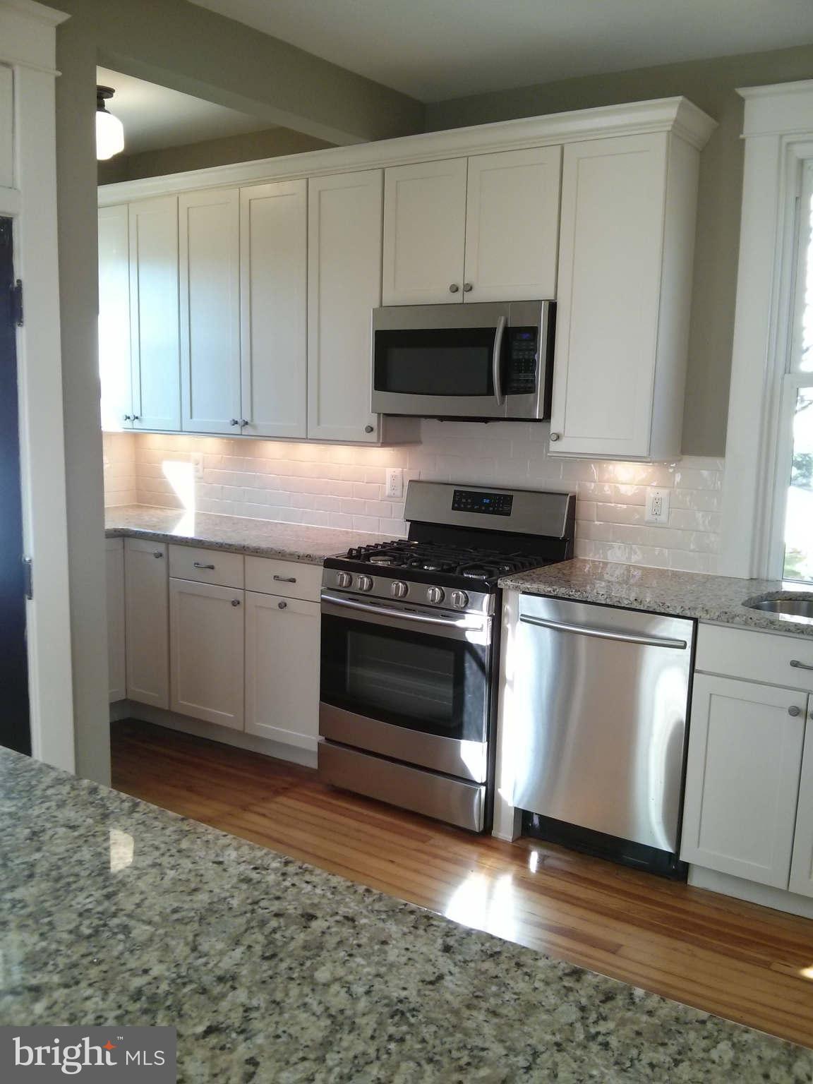 646 Orpington Road Baltimore, MD 21229 - Photo 2 of 30 a kitchen with granite countertop a stove and a sink