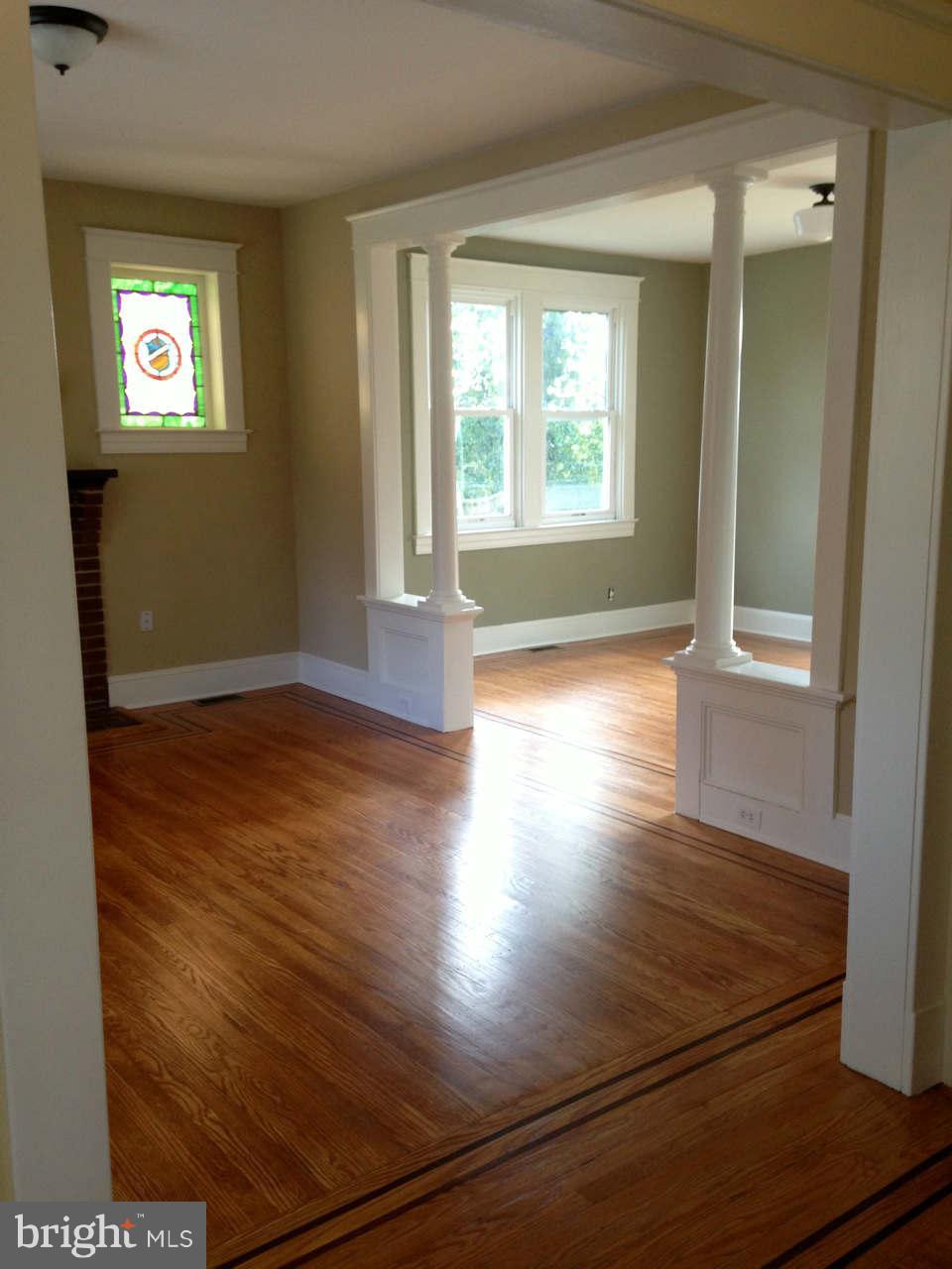646 Orpington Road Baltimore, MD 21229 - Photo 12 of 30 an empty room with wooden floor and windows