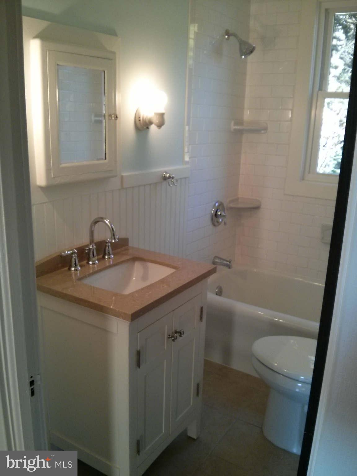 646 Orpington Road Baltimore, MD 21229 - Photo 13 of 30 a bathroom with a sink a toilet a mirror and shower