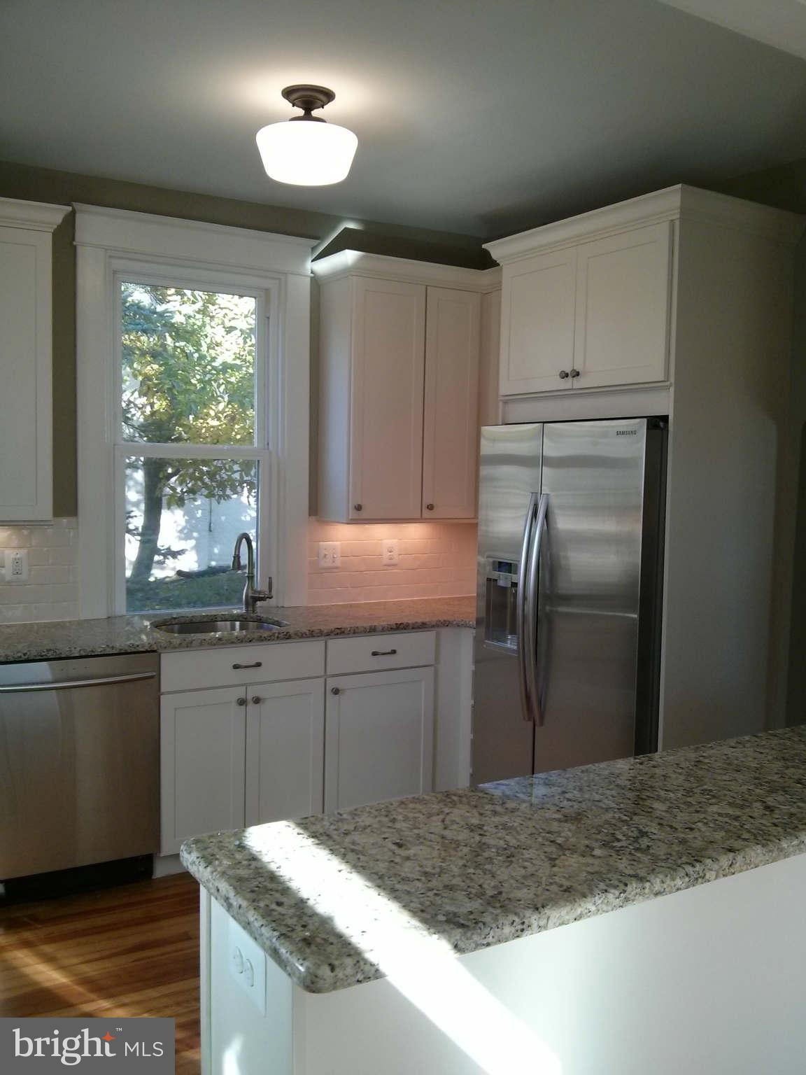 646 Orpington Road Baltimore, MD 21229 - Photo 3 of 30 a kitchen with a sink refrigerator and microwave
