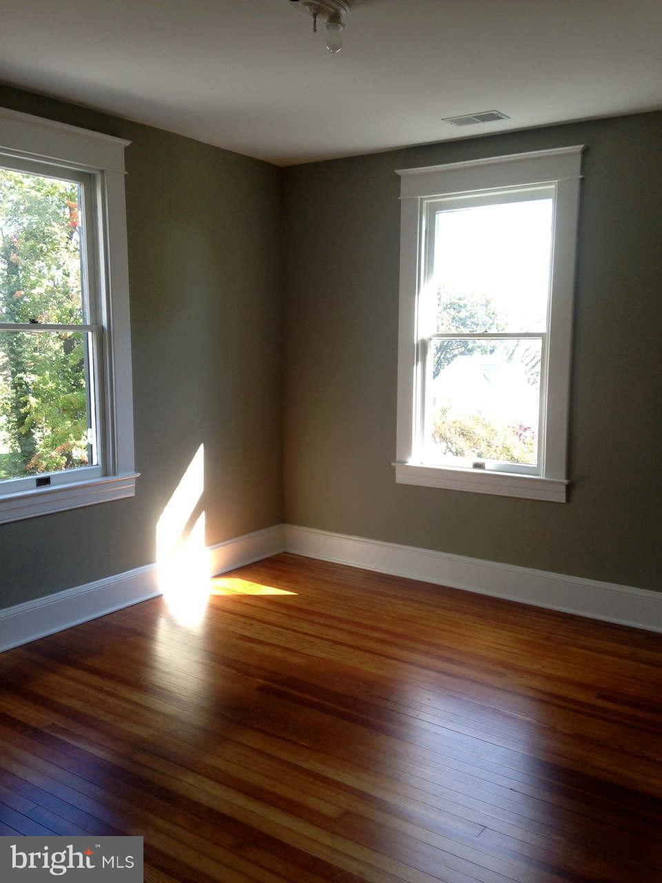 646 Orpington Road Baltimore, MD 21229 - Photo 27 of 30 a view of empty room with wooden floor and fan