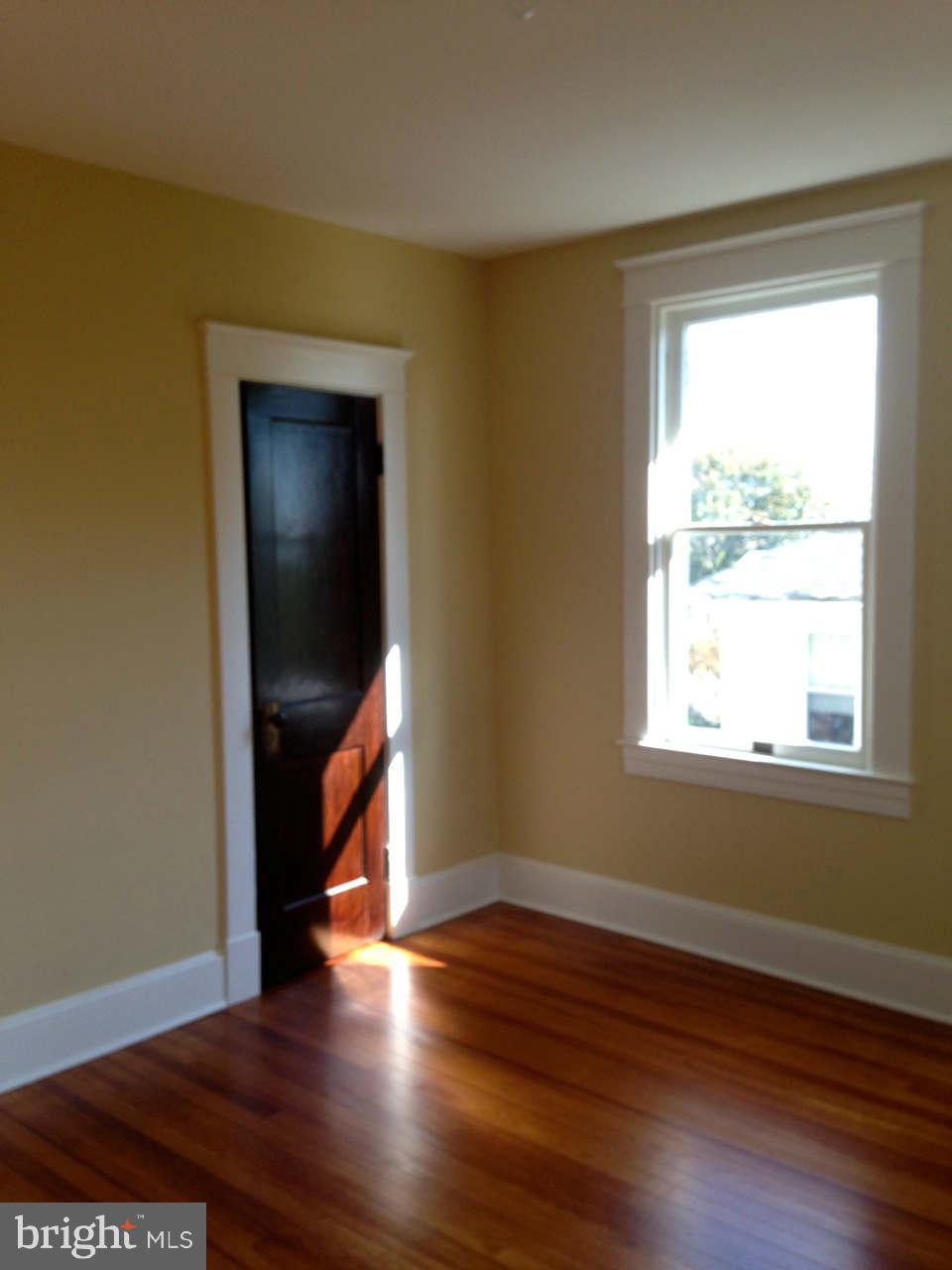 646 Orpington Road Baltimore, MD 21229 - Photo 29 of 30 a view of an empty room with wooden floor and a window