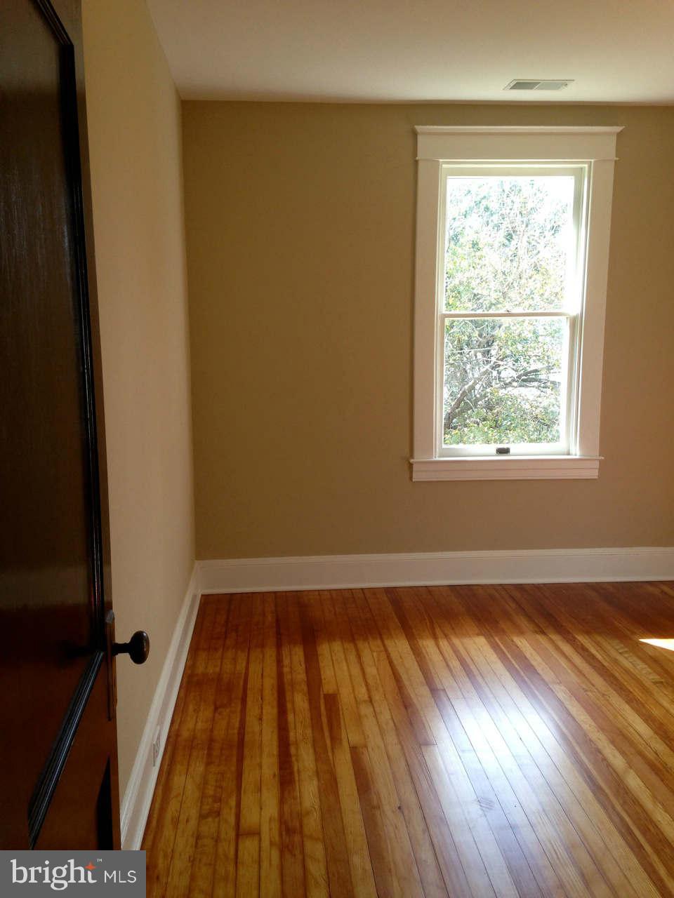 646 Orpington Road Baltimore, MD 21229 - Photo 30 of 30 a view of an empty room with wooden floor and a window