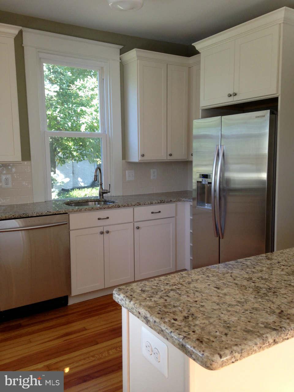 646 Orpington Road Baltimore, MD 21229 - Photo 4 of 30 a kitchen with kitchen island sink refrigerator and window