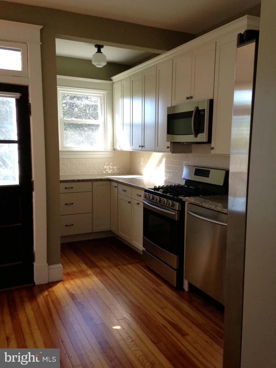 646 Orpington Road Baltimore, MD 21229 - Photo 6 of 30 a kitchen with stainless steel appliances granite countertop a stove a sink and a microwave