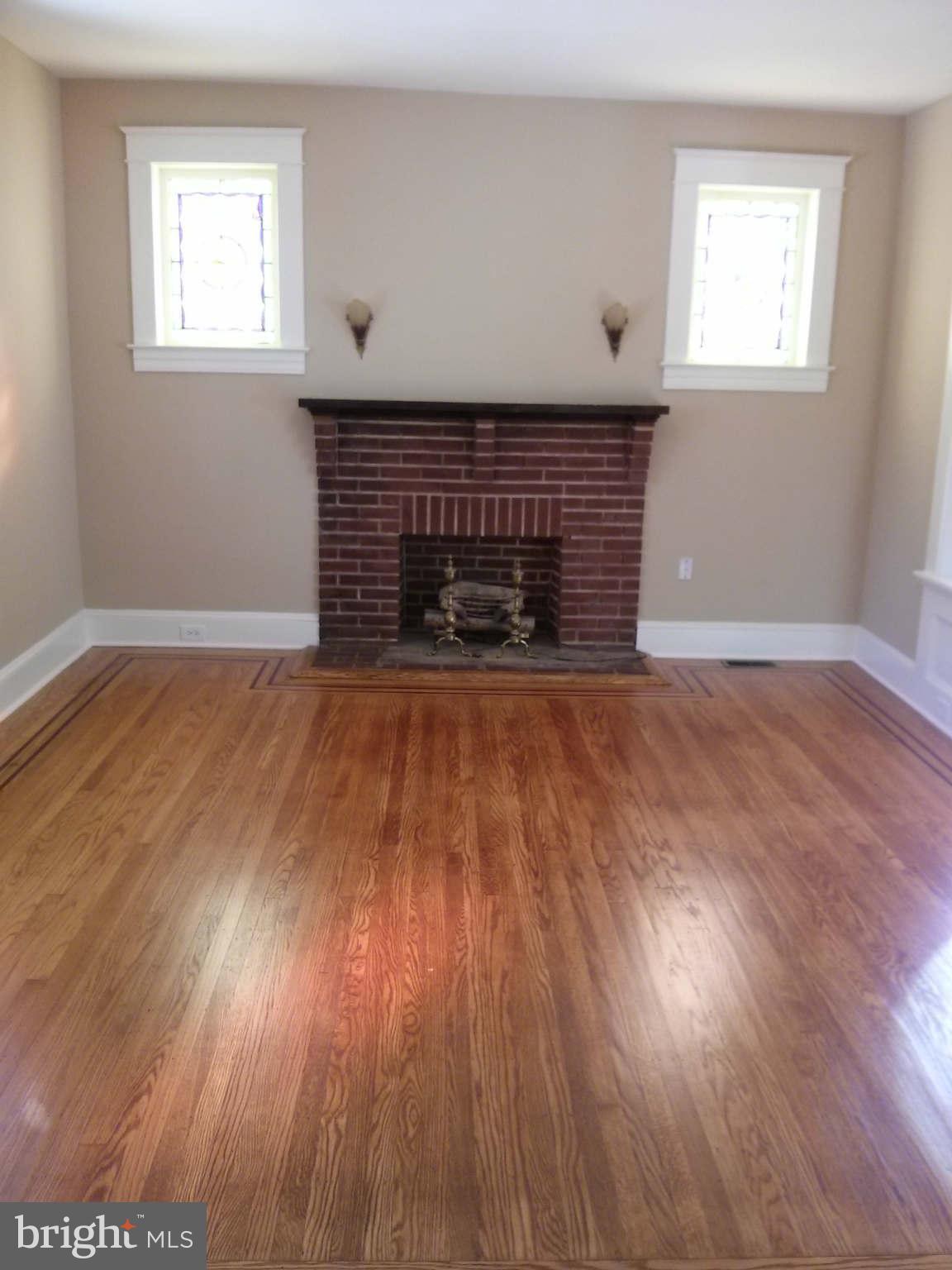 646 Orpington Road Baltimore, MD 21229 - Photo 10 of 30 a view of an empty room with wooden floor and a window