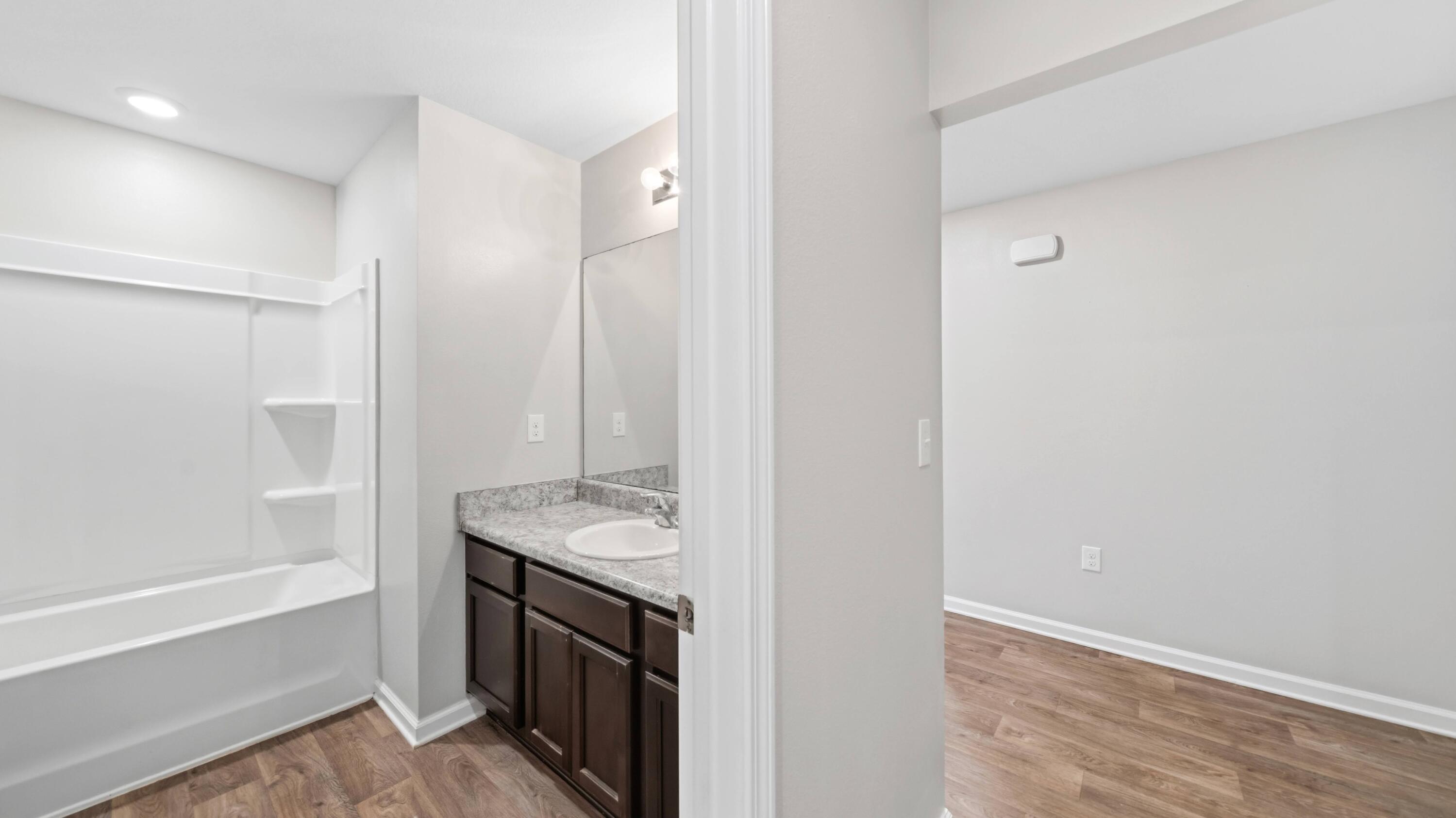 3927 Alva Thomas Road Panama City, FL 32404 - Photo 27 of 46 a bathroom with a sink a granite counter and a shower
