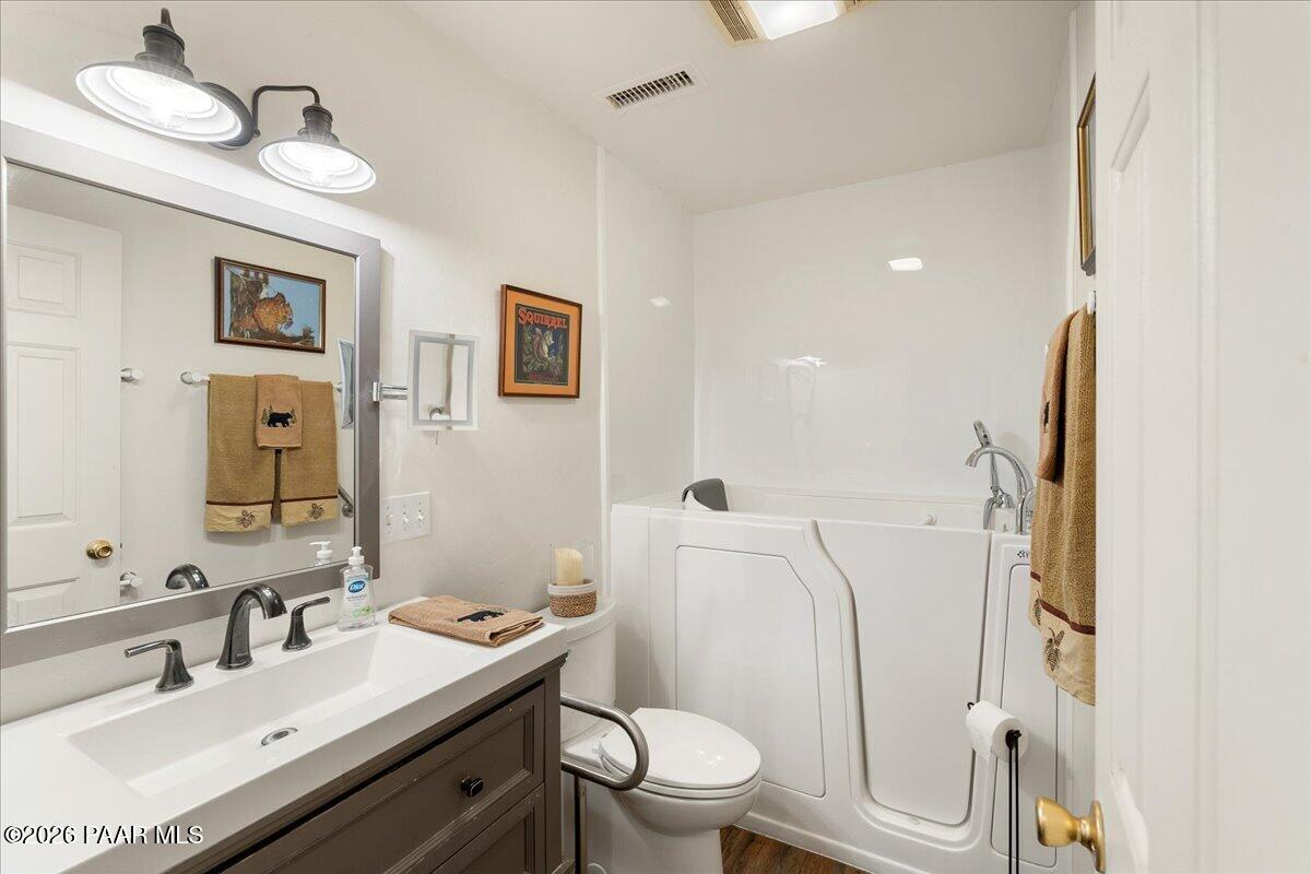 1388 East Pine Ridge Drive Prescott, AZ 86303 - Photo 11 of 16 a bathroom with a sink vanity mirror and toilet